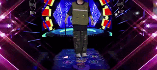 Child playing dance game on interactive mat with music and lights