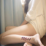 Realistic stitch wound Halloween temporary tattoo applied to woman's leg.