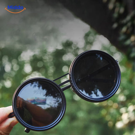 Handmade sunglasses held in hand showing dark UV-protective lens.
