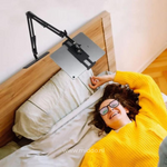 FlexArm tablet holder mounted securely on bed headboard for comfortable use.