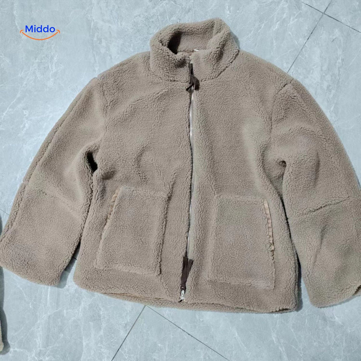 Beige teddy wool coat laid flat on floor showing overall dimensions and fit.