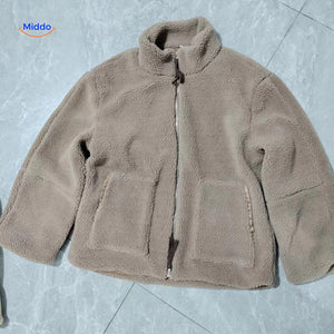 Beige teddy wool coat laid flat on floor showing overall dimensions and fit.