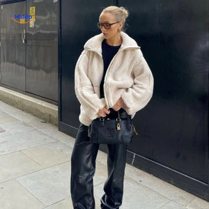 Beige teddy wool coat styled on stairs, showing fit and everyday wearability.