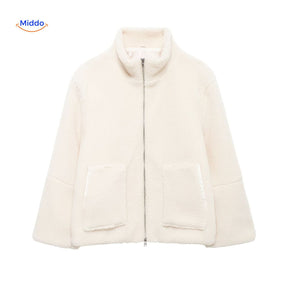 Beige teddy wool coat in studio lighting, showcasing material and color.
