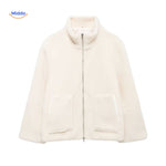 Beige teddy wool coat in studio lighting, showcasing material and color.