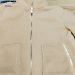 Beige teddy wool coat on white background for clean product presentation.