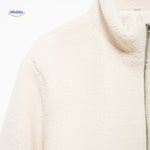 White teddy wool coat chest area closeup displaying collar and upper details.