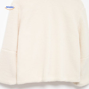 White teddy wool coat pocket detail showing functional design and placement.