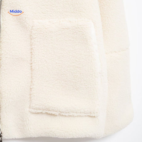 White teddy wool coat upper zipper detail showing collar and neck construction.