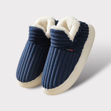 Blue therapeutic fleece winter slippers with white cushioned lining and non-slip sole.
