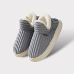 Grey therapeutic fleece winter slippers with white cushioned lining and non-slip sole.