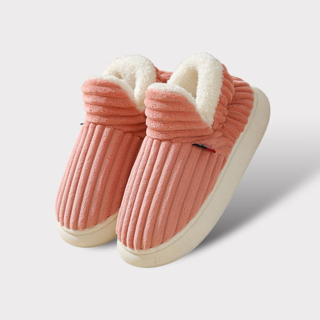 Pink therapeutic fleece winter slippers with white cushioned lining and non-slip sole.