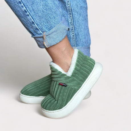 Green therapeutic fleece winter slippers with white cushioned lining and non-slip sole.
