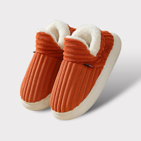 Orange therapeutic fleece winter slippers with white cushioned lining and non-slip sole.