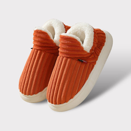 Orange therapeutic fleece winter slippers with white cushioned lining and non-slip sole.