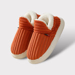 Orange therapeutic fleece winter slippers with white cushioned lining and non-slip sole.