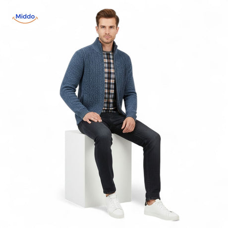 Men's thermoknit vest layered over plaid shirt in seated pose for casual styling inspiration.