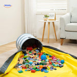 Toy storage bag filled with colorful blocks displayed in a living room setting.