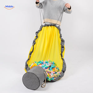 Toy bag being lifted by handles for convenient storage and transport.