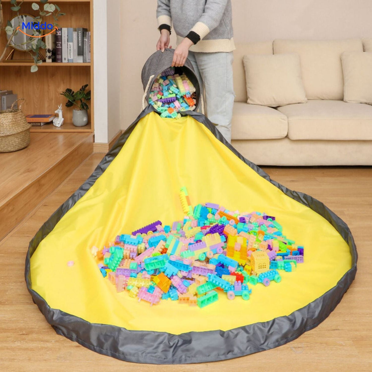Storage tote bag spread open with toys pouring out for easy cleanup.