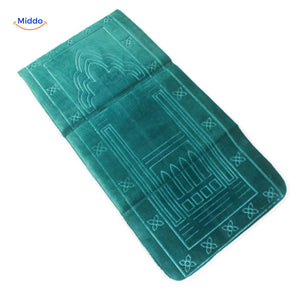 Compact padded travel prayer mat in green, folded for portability and easy storage.