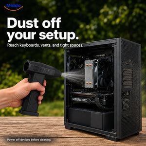 Black TurboJet Pro blowing dust from an open desktop computer with a reminder to power off before cleaning