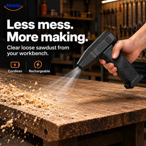 Black TurboJet Pro cordless air duster clearing loose sawdust from a wooden workbench