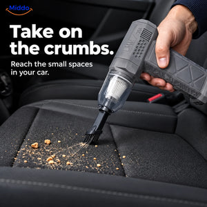 Gray TurboJet Pro with a filter cup and brush attachment cleaning crumbs from a car seat