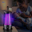 Electric UV insect trap in action in bedroom for chemical-free pest control.