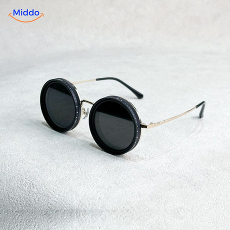 Golden frame handmade sunglasses with adjustable light reduction capability.