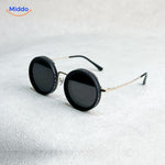 Golden frame handmade sunglasses with adjustable light reduction capability.