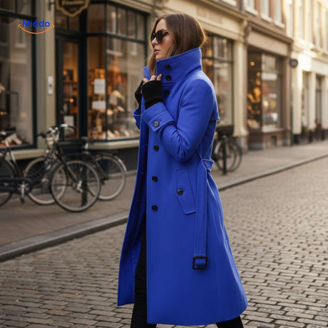 Blue button-front Veloura coat paired with sunglasses in casual style.
