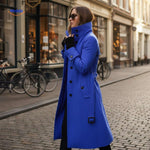 Blue button-front Veloura coat paired with sunglasses in casual style.