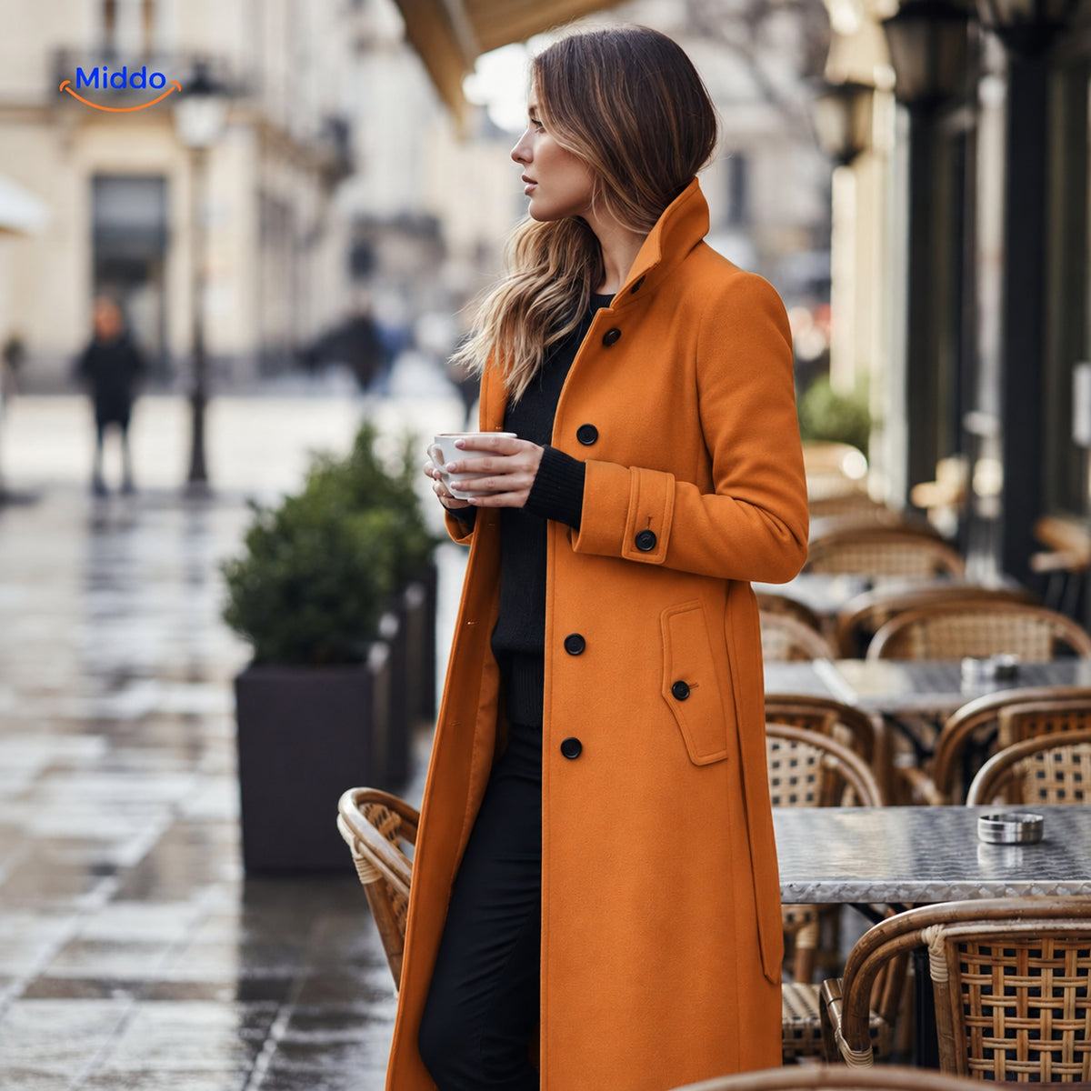 Stylish Veloura button-front women's coat worn at outdoor café setting.