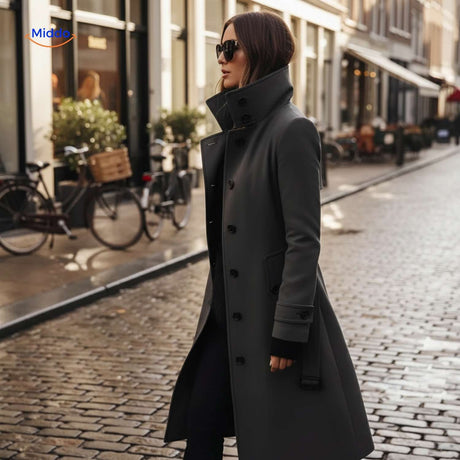 Woman walking in grey Veloura button-front coat on city street.