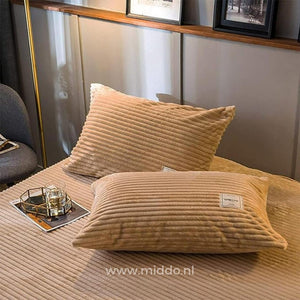 Two beige velvet fleece pillowcases add softness to your sleep setup.