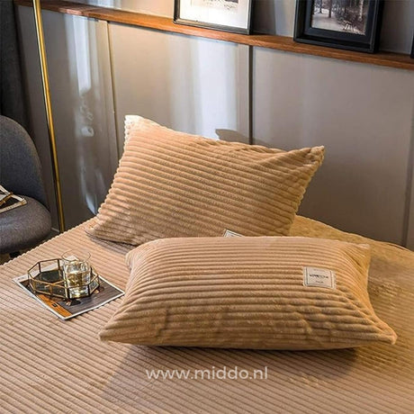 Two beige velvet fleece pillowcases add softness to your sleep setup.