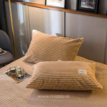 Two beige velvet fleece pillowcases add softness to your sleep setup.