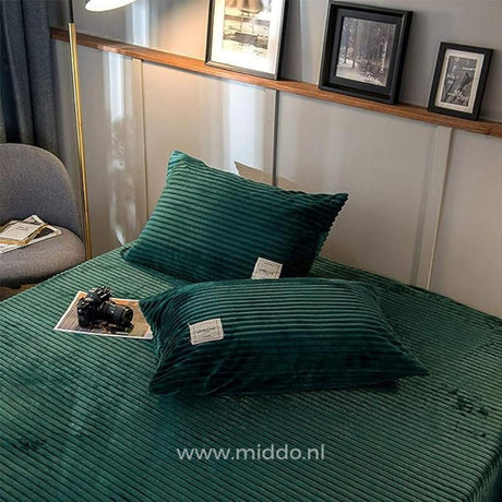 Pair of dark green velvet fleece pillowcases complement your bedding.