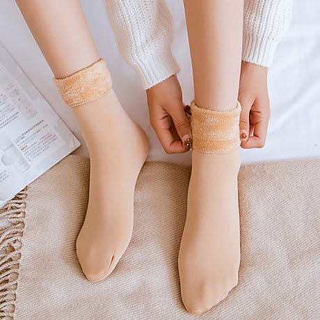 Beige velvet socks close-up highlighting soft fabric texture.