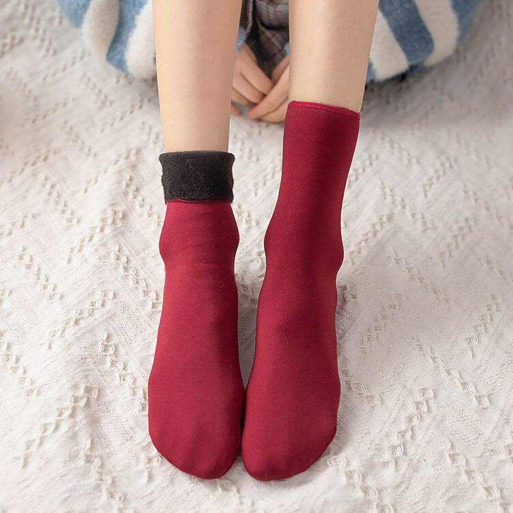 Red velvet socks displaying soft plush texture and warmth.