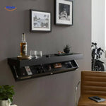 Black floating wall shelf with multiple easy-access storage compartments.