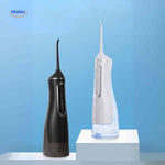 White and black cordless water flosser variants displayed on charging stand.