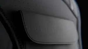 Close-up detail of waterproof premium fabric flap on reflective running vest for protection.