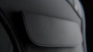 Close-up detail of waterproof premium fabric flap on reflective running vest for protection.