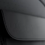 Close-up detail of waterproof premium fabric flap on reflective running vest for protection.