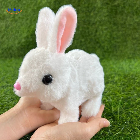 White plush bunny toy held gently in hand, showing its soft fur texture and compact cuddly size.