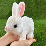 White plush bunny toy held gently in hand, showing its soft fur texture and compact cuddly size.