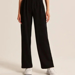 Wide-leg trousers in classic black with sleek design and versatile neutral tone.