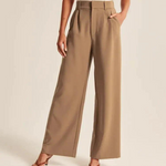 Women's wide-leg trousers in warm brown showing flattering drape and tailored details.